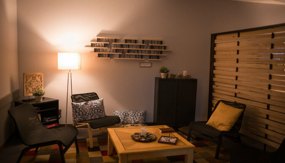 A cozy prayer room with dim lighting and comfy furniture.