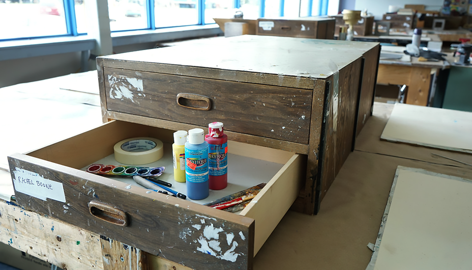 Artist's drawer with multiple supplies.