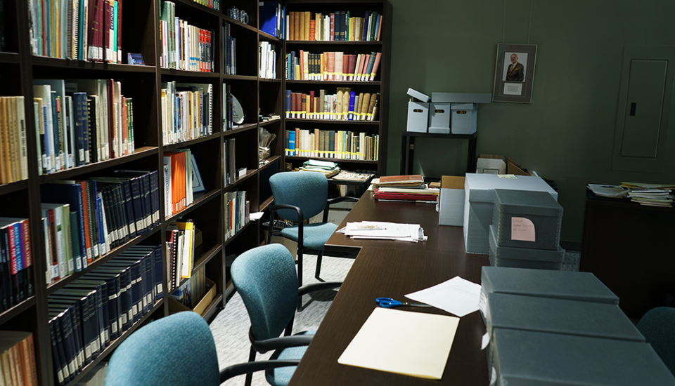 Reading room with many bookshelves full of books.