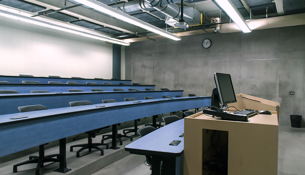 Multiple rows of theater style desks for lectures.