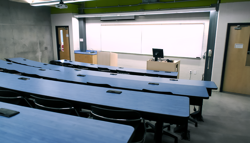 Large room with theater seating and desk space.