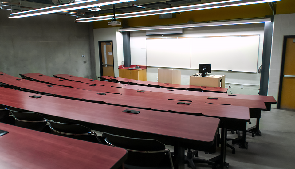 Large room with theater seating and desk space.