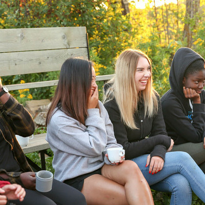 Students around a campfire at the Fall Retreat.