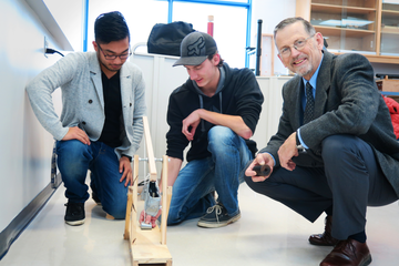Physics and astronomy professor emeritus Dr Brian Martin, building a model trebuchet with students.